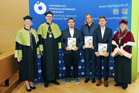 Kadry z inauguracji roku akademickiego w Audytorium Aleksandra Jabłońskiego - kolegium dziekańskie wraz z prorektorką za stołem oraz studenci i nauczyciele oraz administracja siedzący na sali. Kliknij, aby powiększyć zdjęcie.