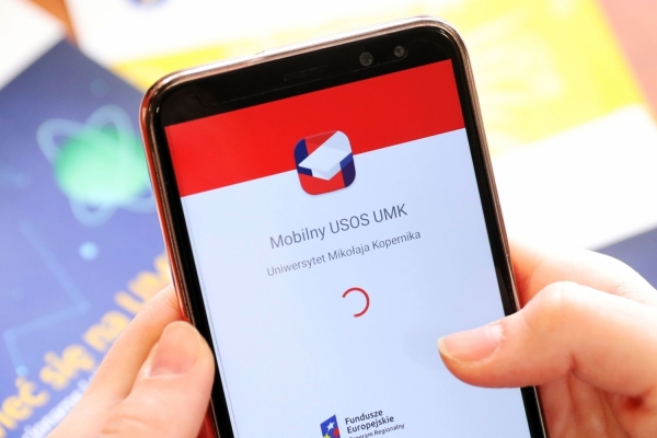 Hands holding smartphone. It displays mobile usos application.