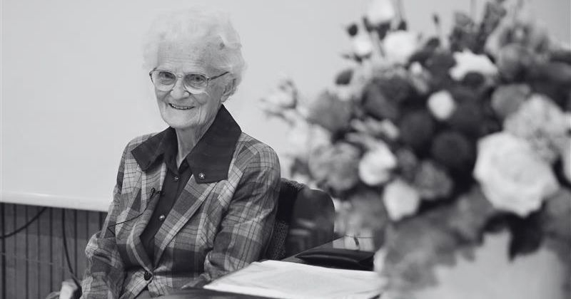 Dr. Cecylia Iwaniszewska, with a vase of flowers beside her, black-and-white photograph